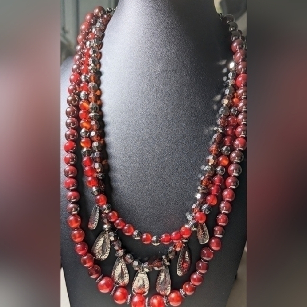 Macy's reddish brown bead necklace on three strands with Silvery accent beading.